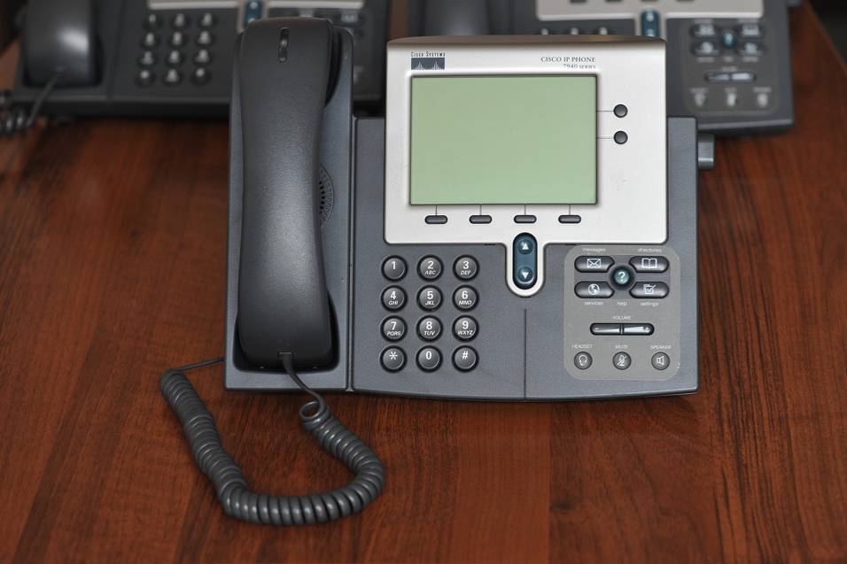 Cisco Work Phone on a Mahogany Desk