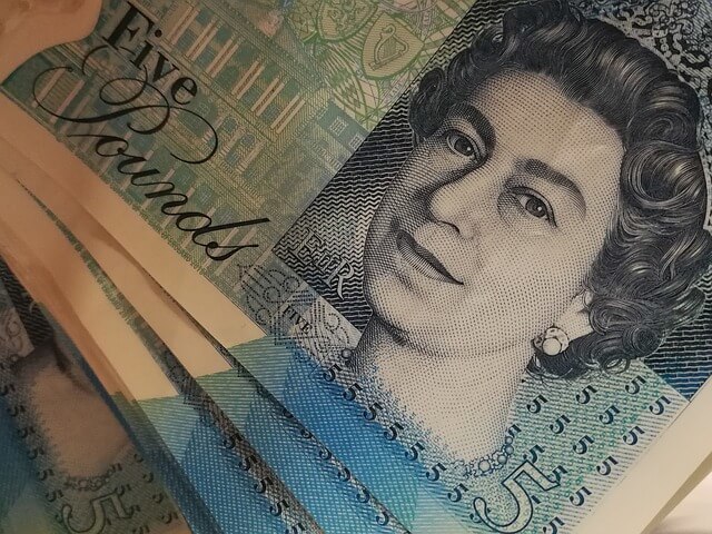 A close-up of five-pound notes. 