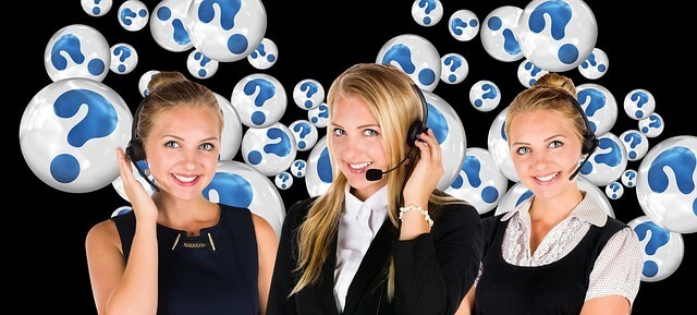 A line of customer support agents with question mark graphics behind them. 